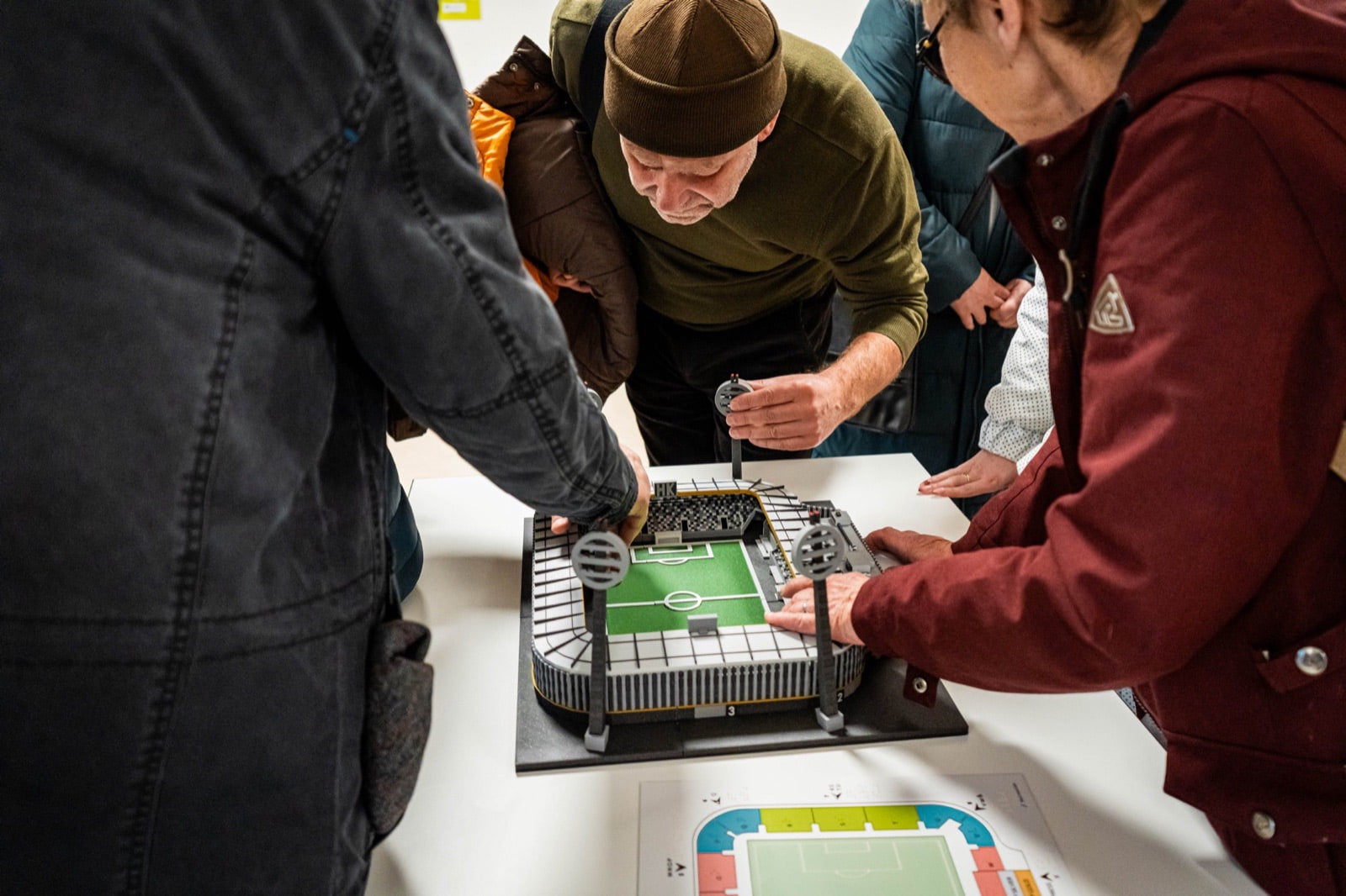Visitors exploring an original tactile stadium model