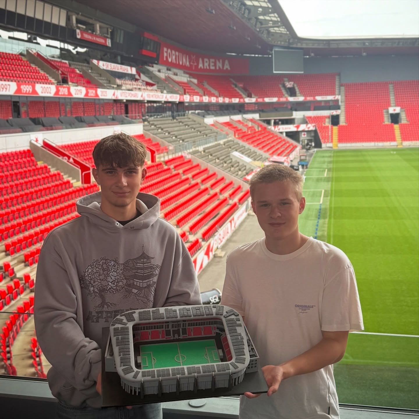 Šimon and David from StadiArt holding the XL Eden model inside Fortuna Arena