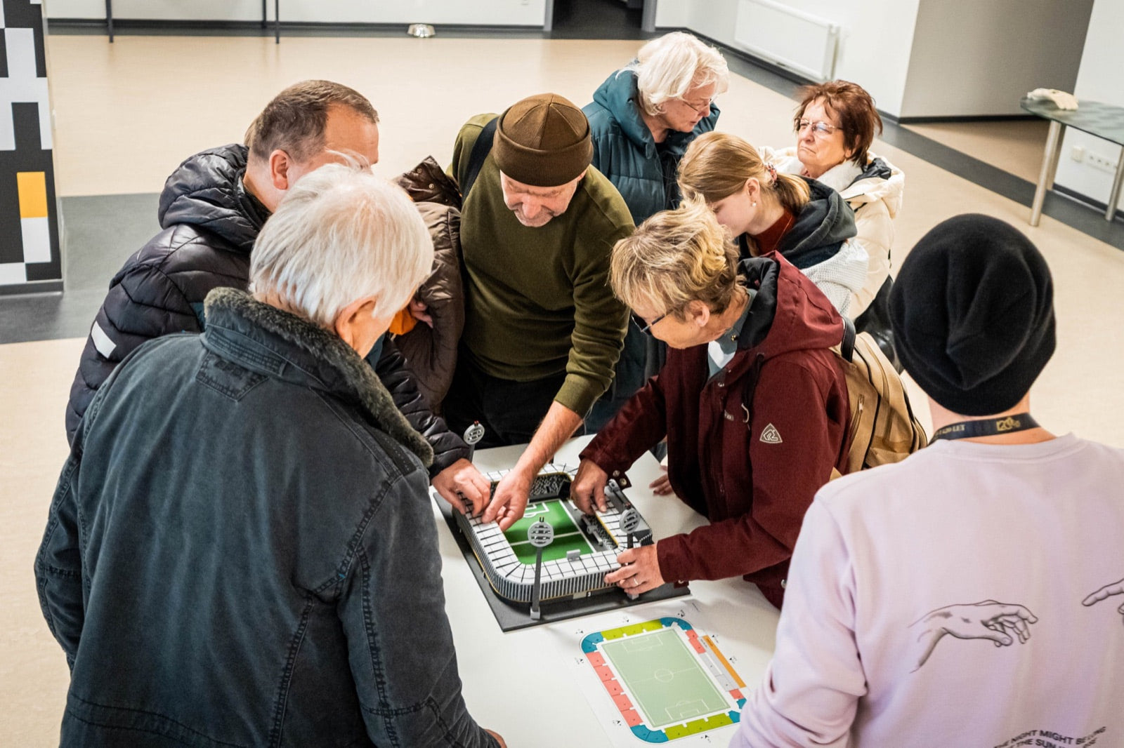 Accessible stadium tour participants gathered around the tactile Malšovická Aréna model