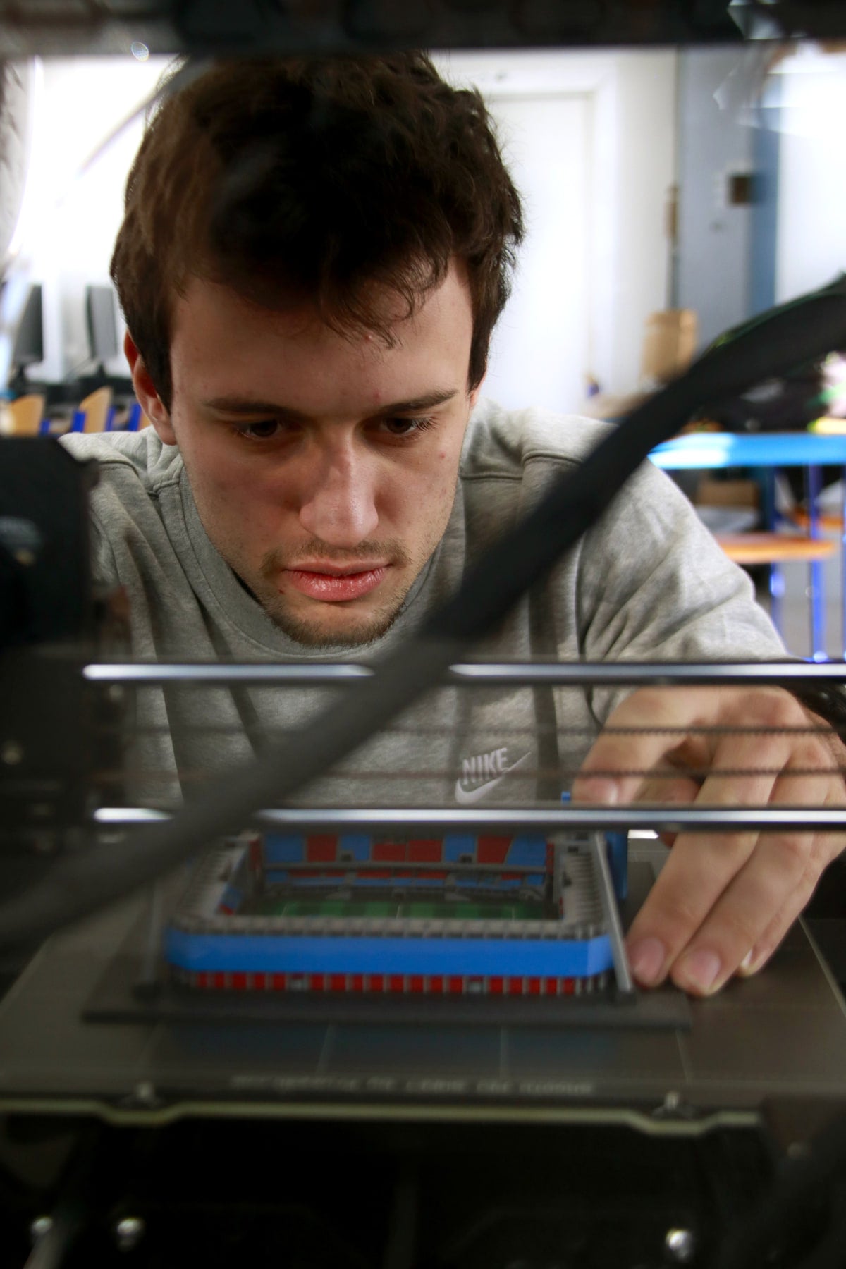 Petr checking a freshly printed stadium model in the StadiArt workshop